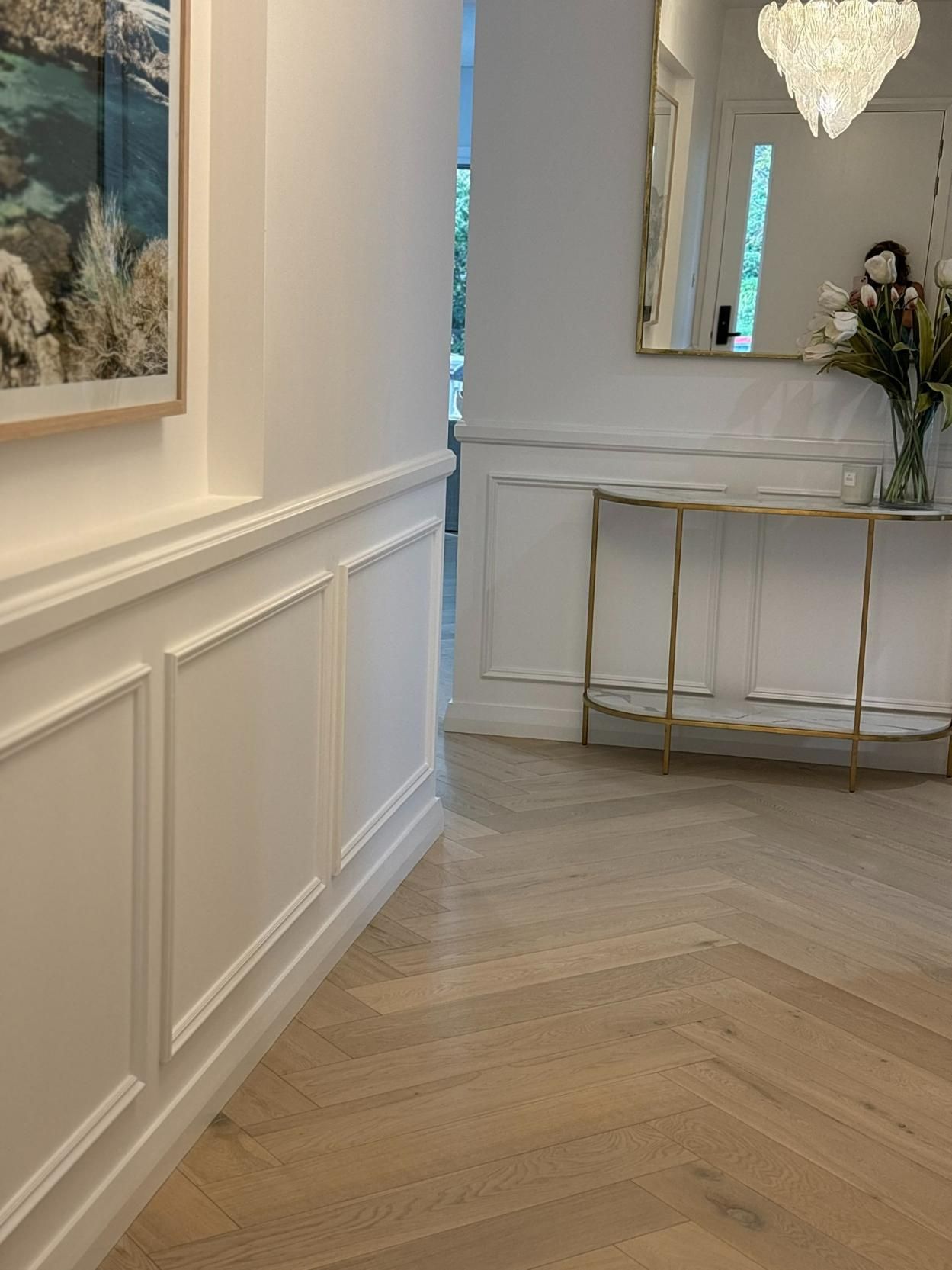 A Hallway With A Table And A Picture On The Wall — Nique Building In Woy Woy, NSW