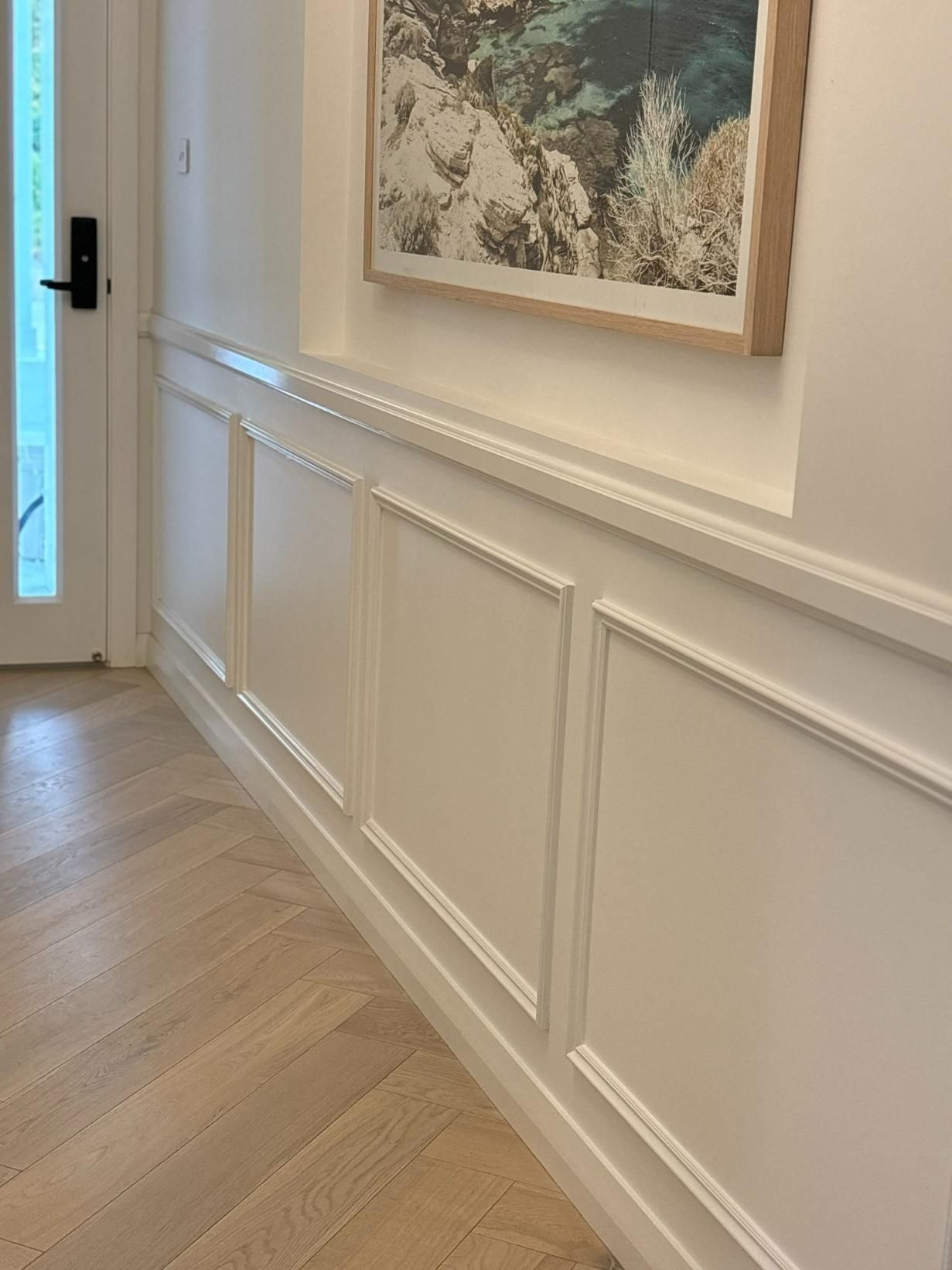 A Hallway With White Paneling And A Picture On The Wall — Nique Building In Wyong, NSW