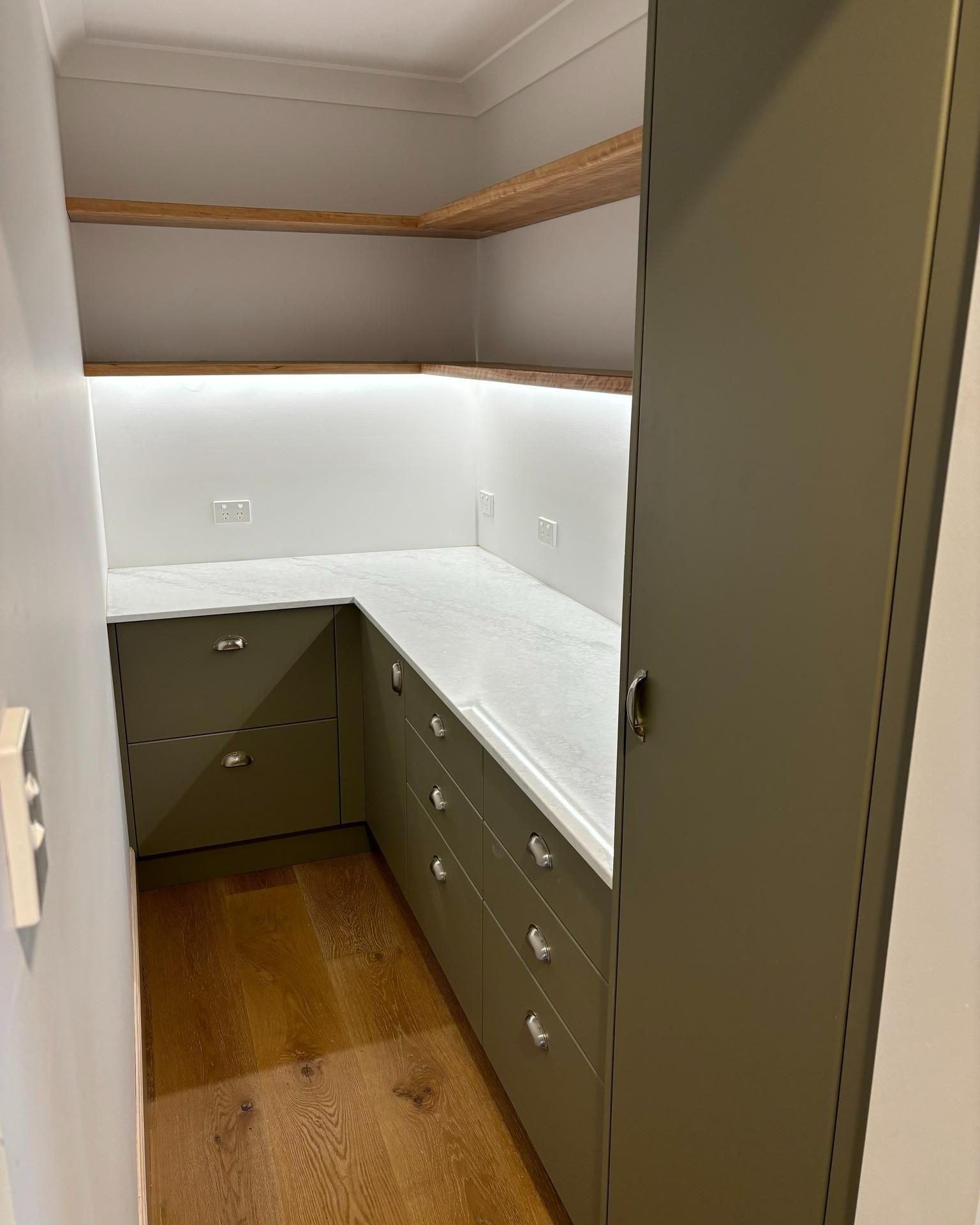 A Kitchen With Green Cabinets And White Counter Tops — Nique Building In Erina Heights, NSW