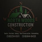 Logo for North Woods Construction with a compass, trees, and roof imagery, plus service list and phone numbers.