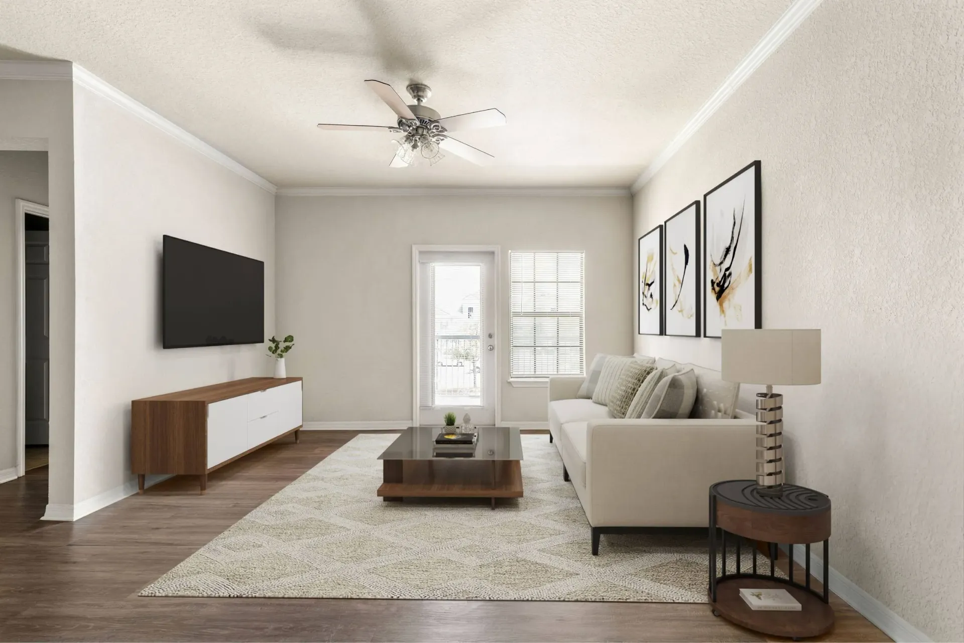 Living room with a couch, coffee table, TV, and ceiling fan at Levi at River City.