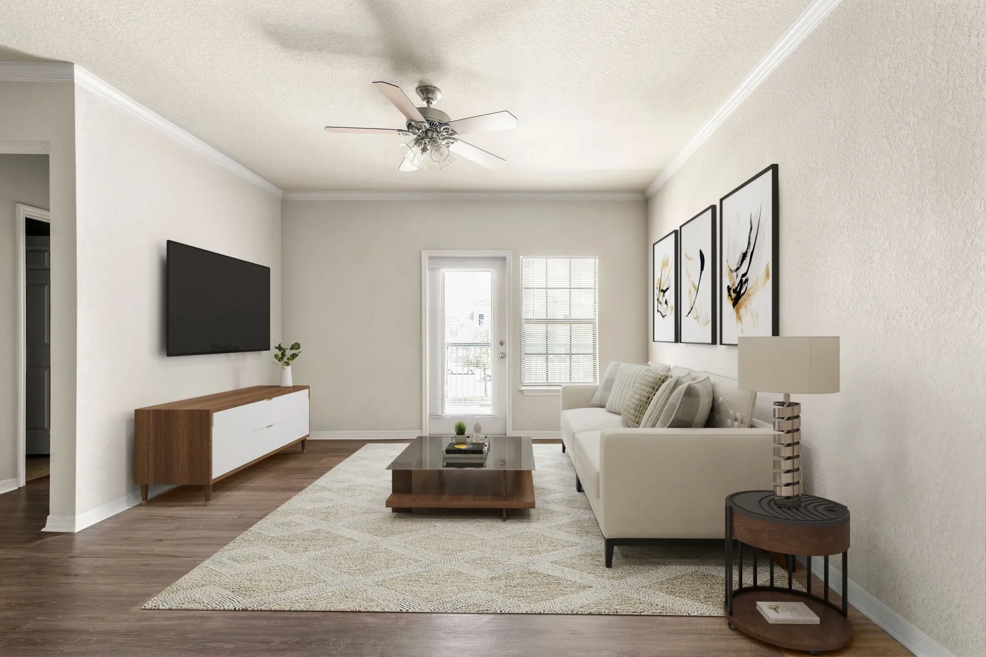A living room with a white couch, a coffee table, and a ceiling fan.
