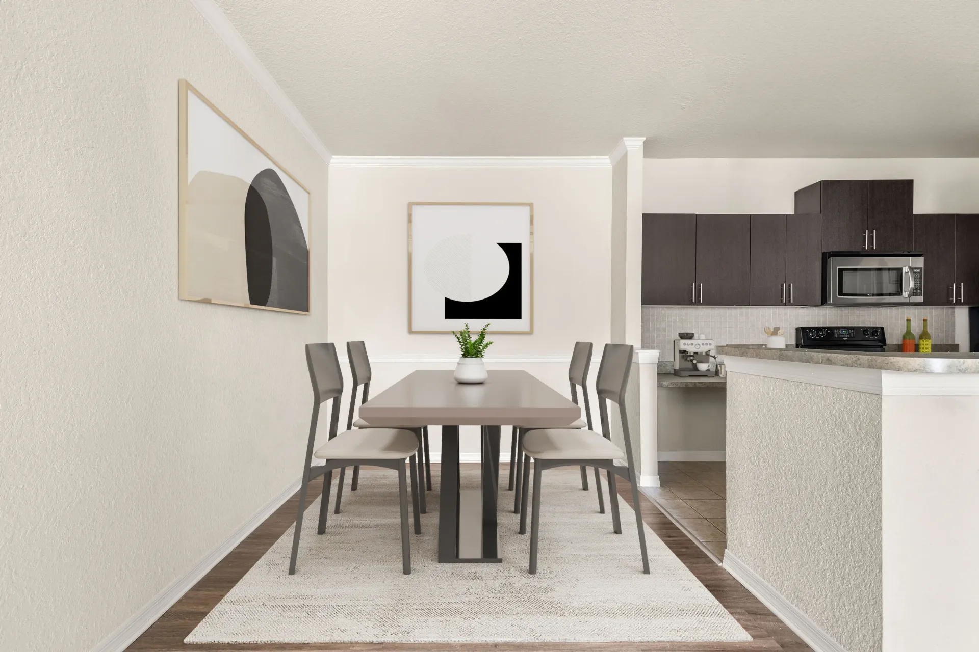 A dining table with chairs and a framed picture on the wall.