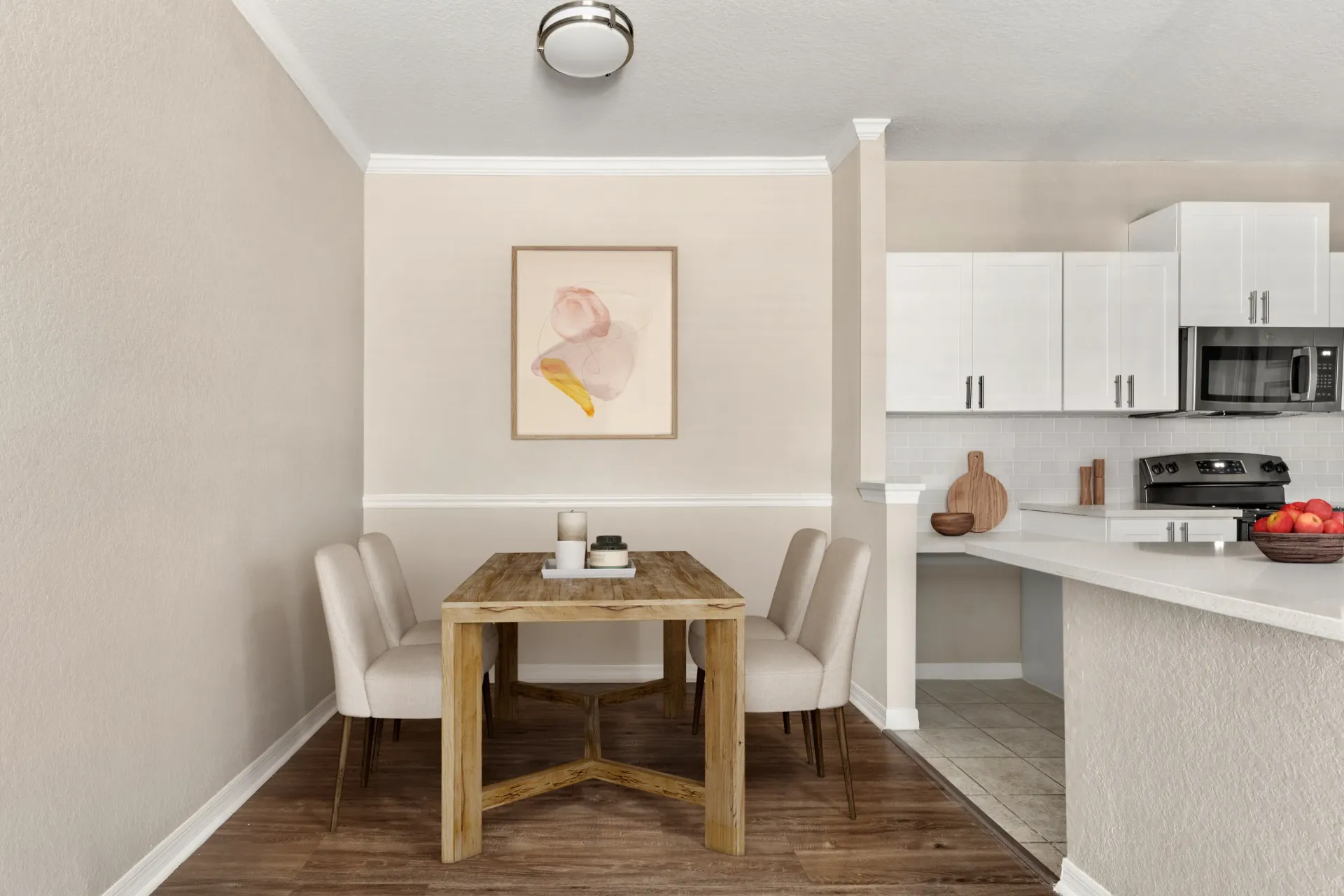 A dining table with chairs and a painting on the wall.
