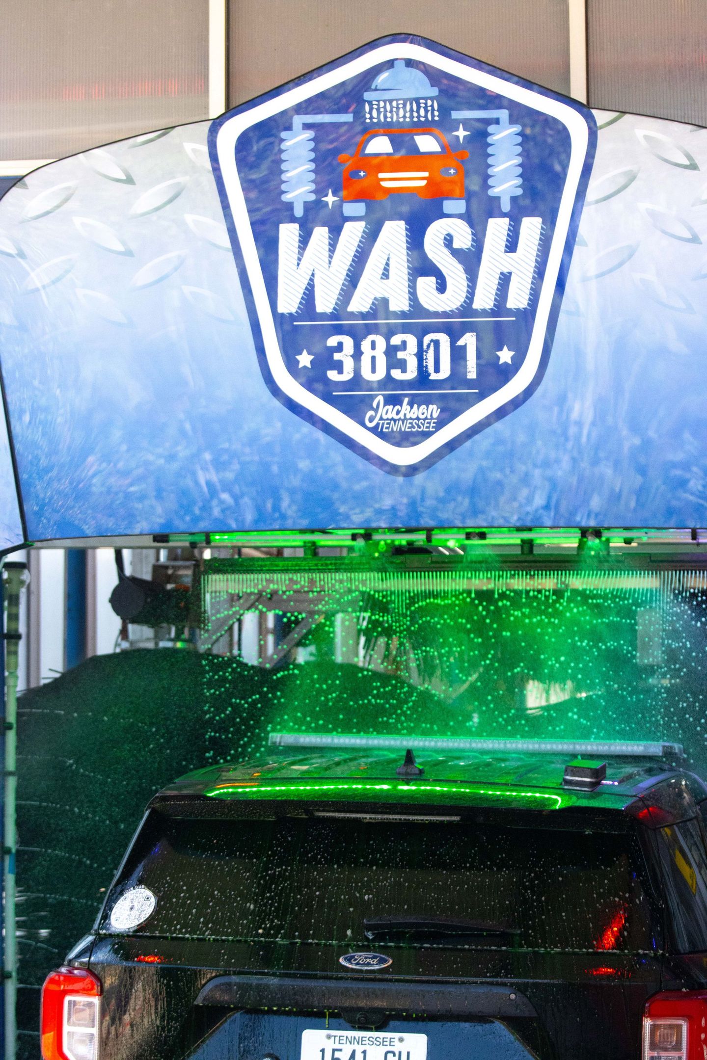 A car is being washed at a car wash.
