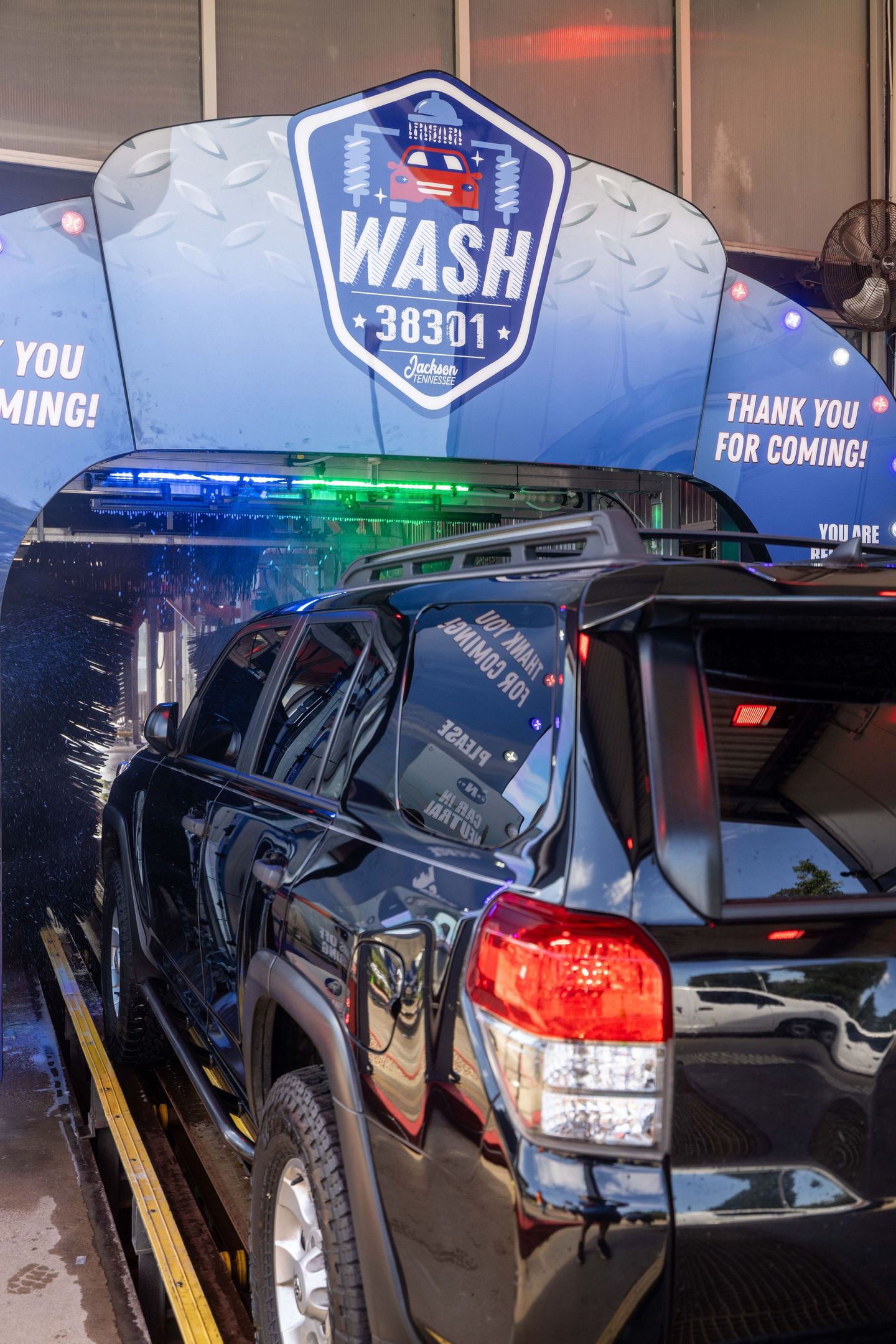 A car is being washed at a car wash.