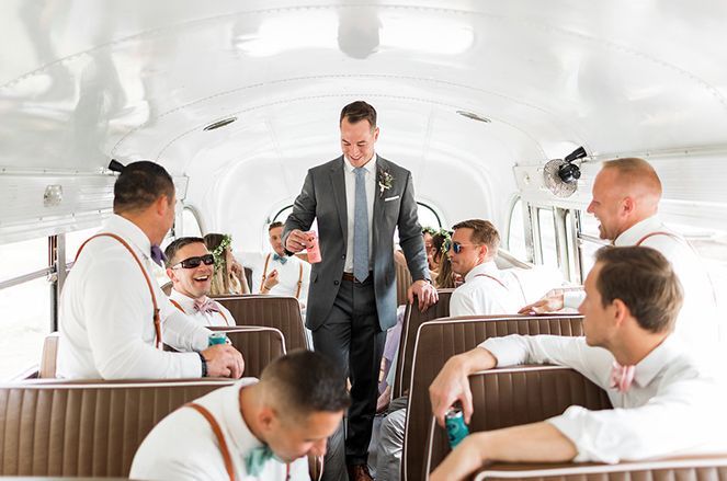 A groom and his groomsmen are sitting on a bus.