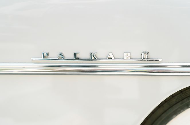 A close up of the backward emblem on a white car.