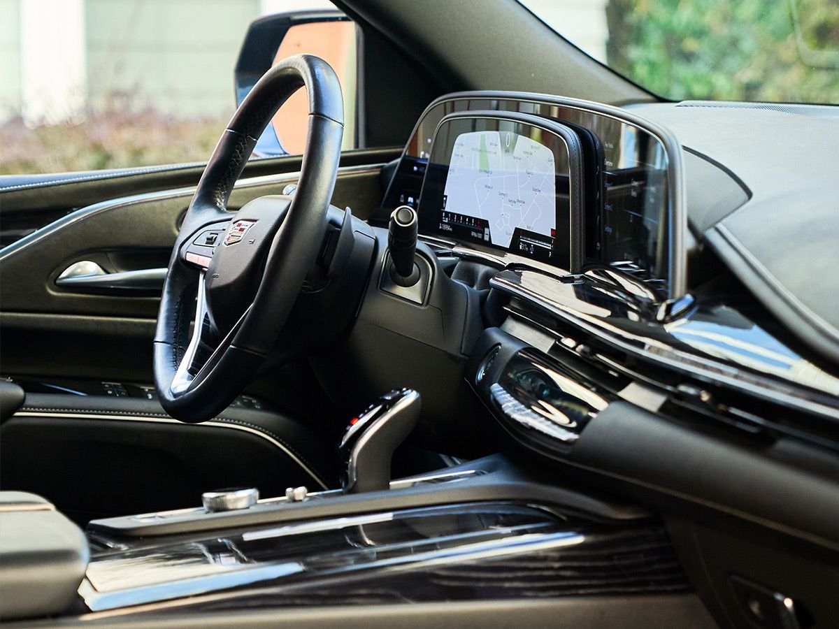 The interior of a car with a steering wheel and dashboard.