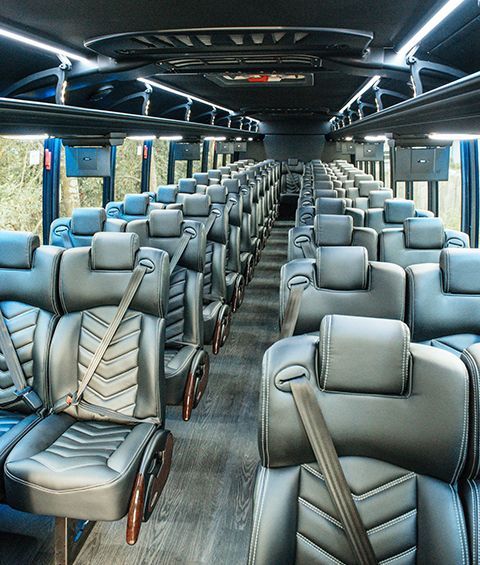 The inside of a bus with a lot of seats and a lot of windows.