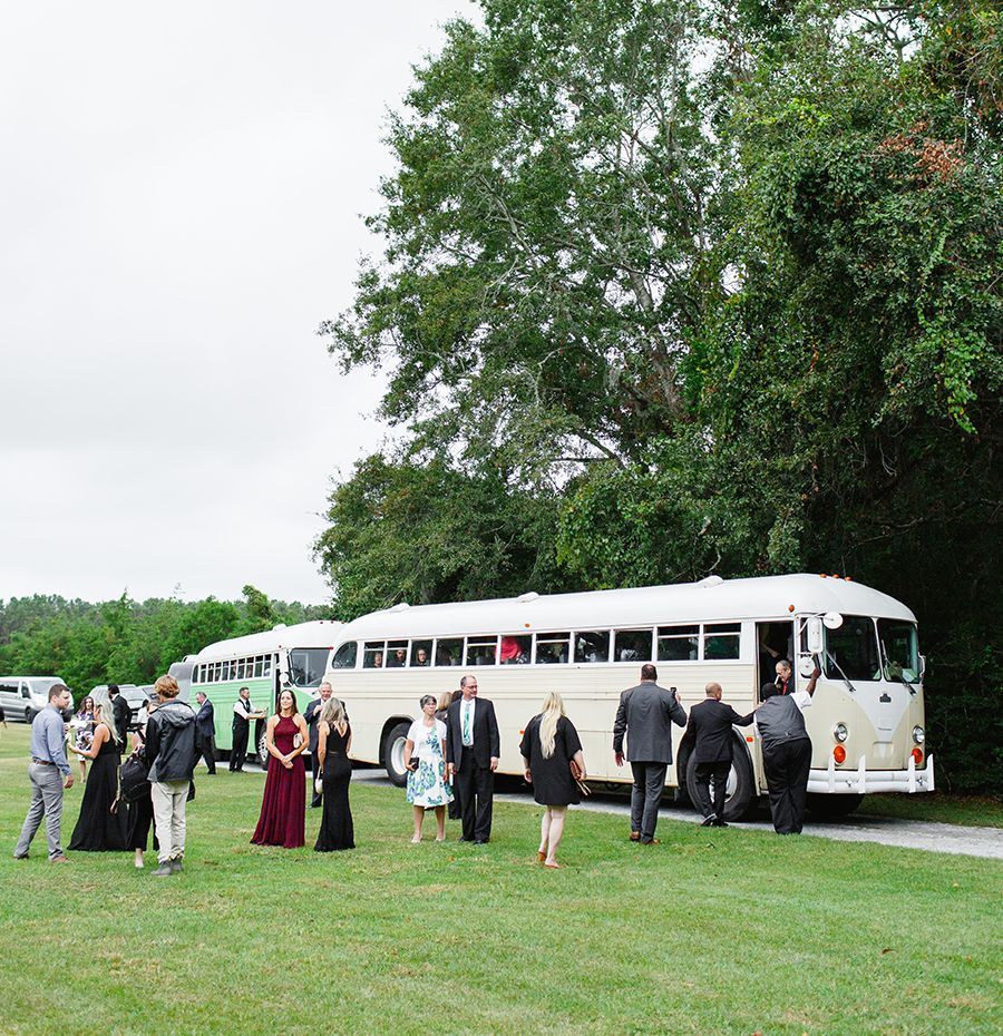 A group of people standing in front of a bus