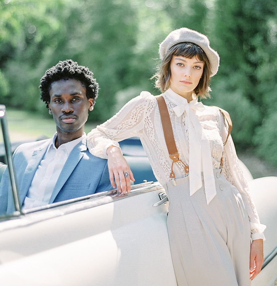 A man and a woman are standing next to each other in a car.