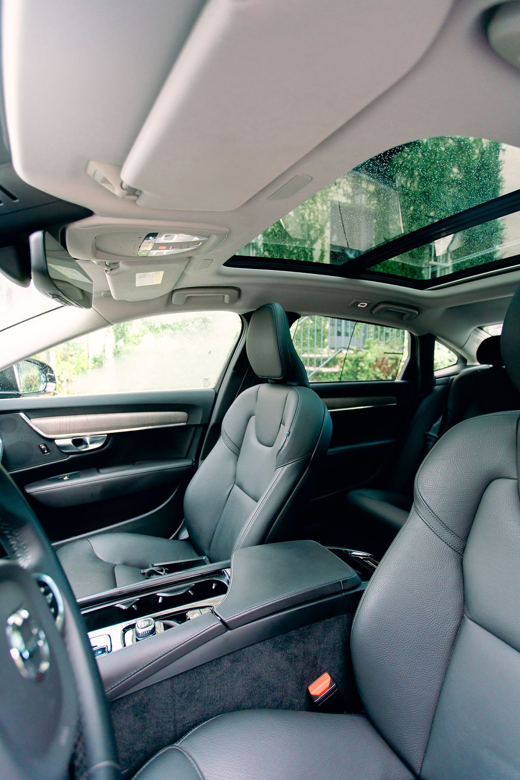 The back seat of a car with two monitors on the headrests.