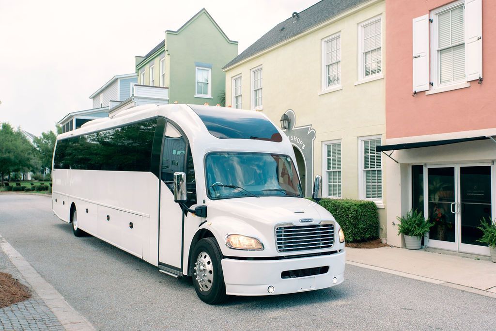 A white bus with the letter l on the front