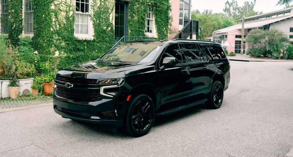 The back seat of a car with two monitors on the headrests.