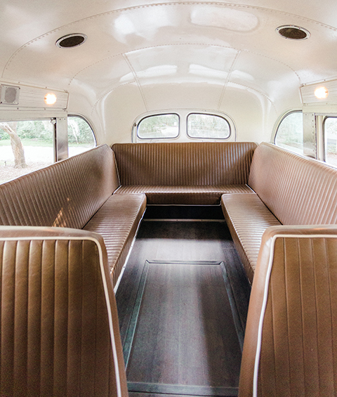 The inside of a bus with brown leather seats