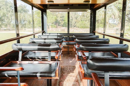 The inside of a bus with a lot of seats and a lot of windows.