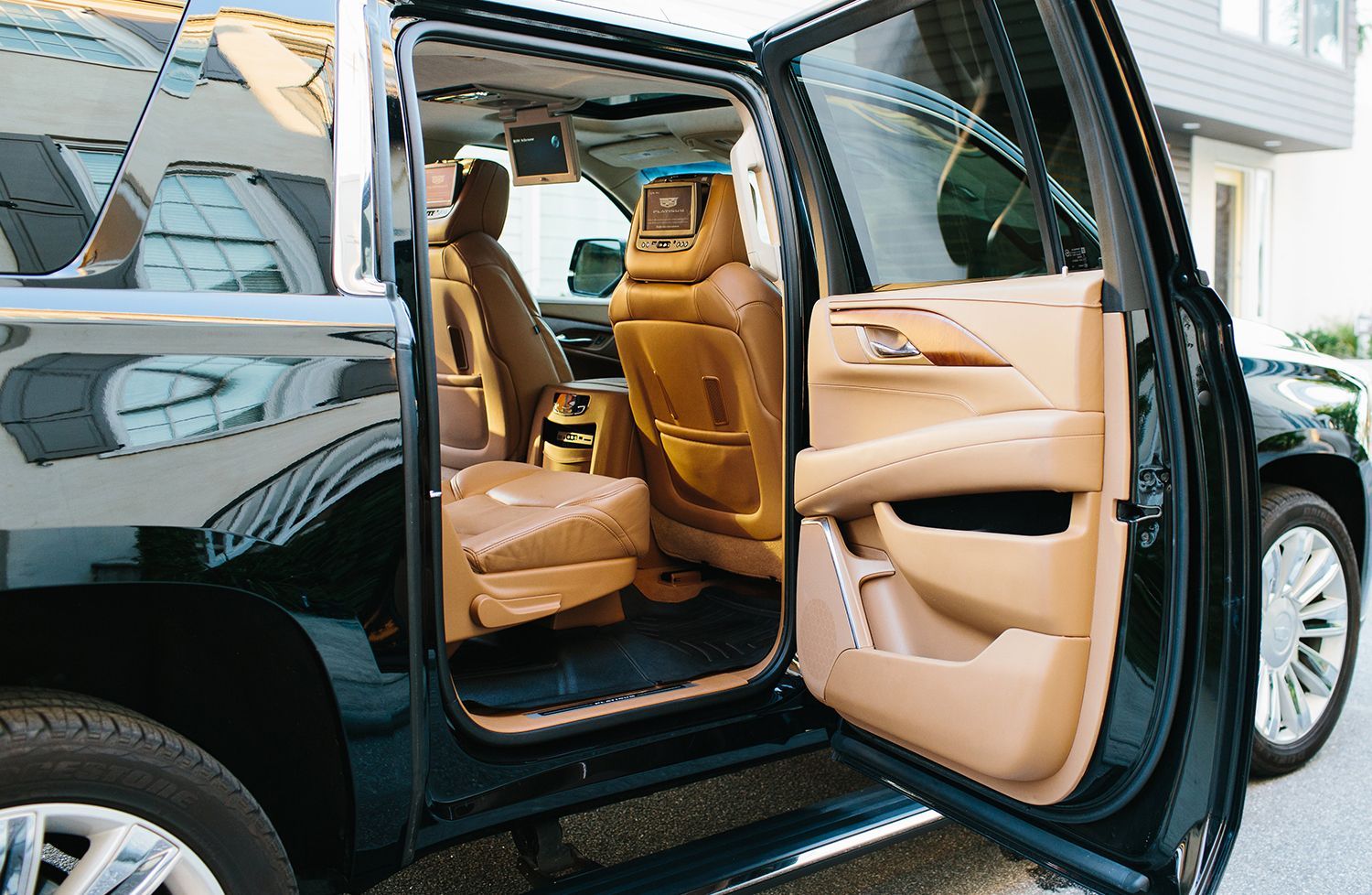 The inside of a black suv with its doors open.