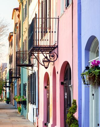 A row of pink and purple buildings with a fire escape