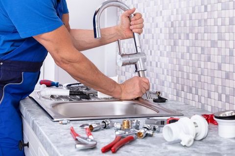 Plumber repairing a faucet — Orange, VA — W.A. Sherman Company