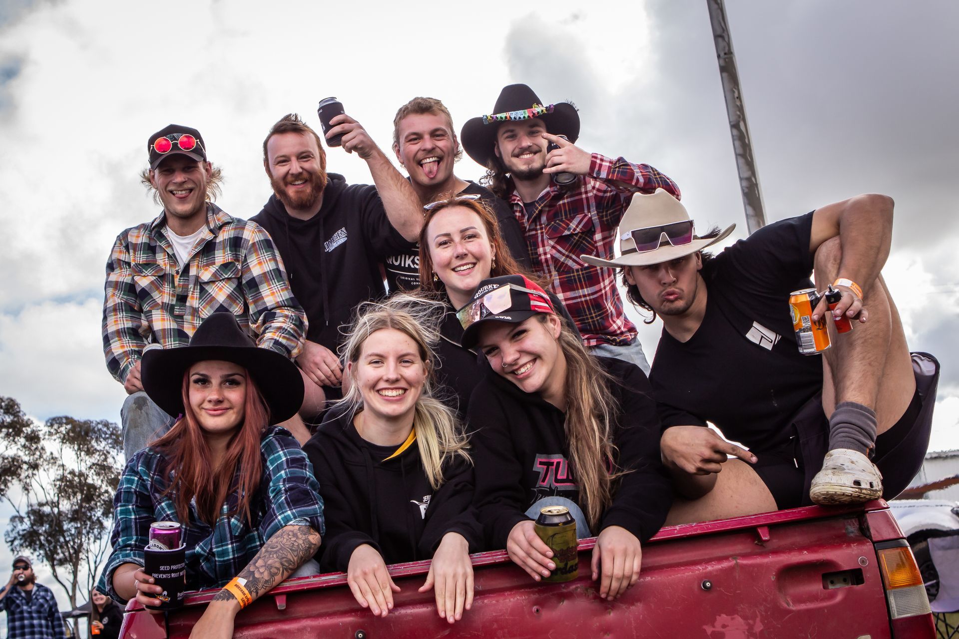 A group of people are posing for a picture in the back of a truck