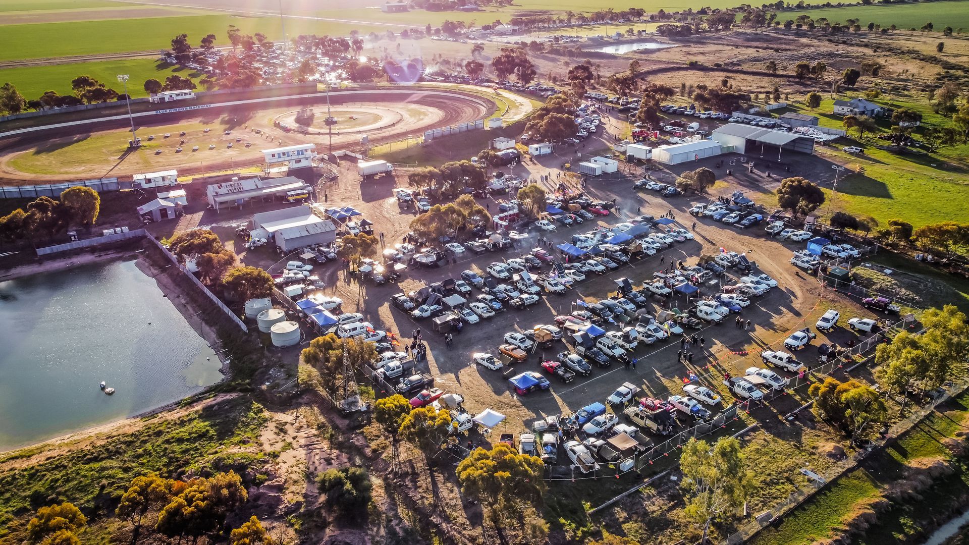 An aerial view of a parking lot filled with lots of cars