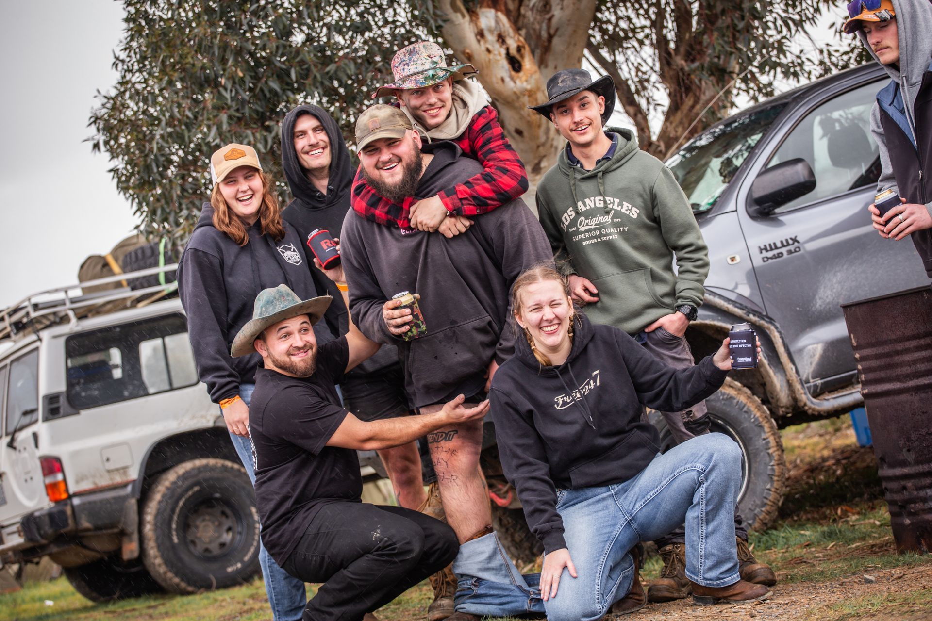 A group of people posing for a picture in front of a toyota