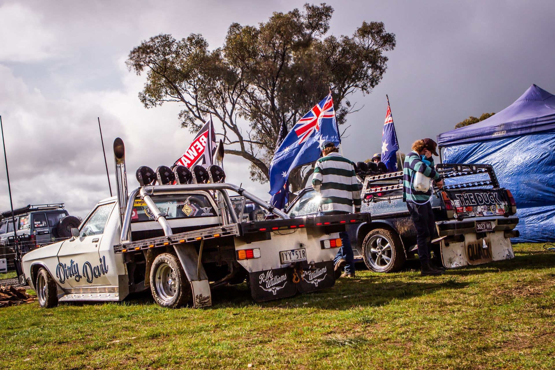 A white truck with a sticker on the back that says ' a ' on it