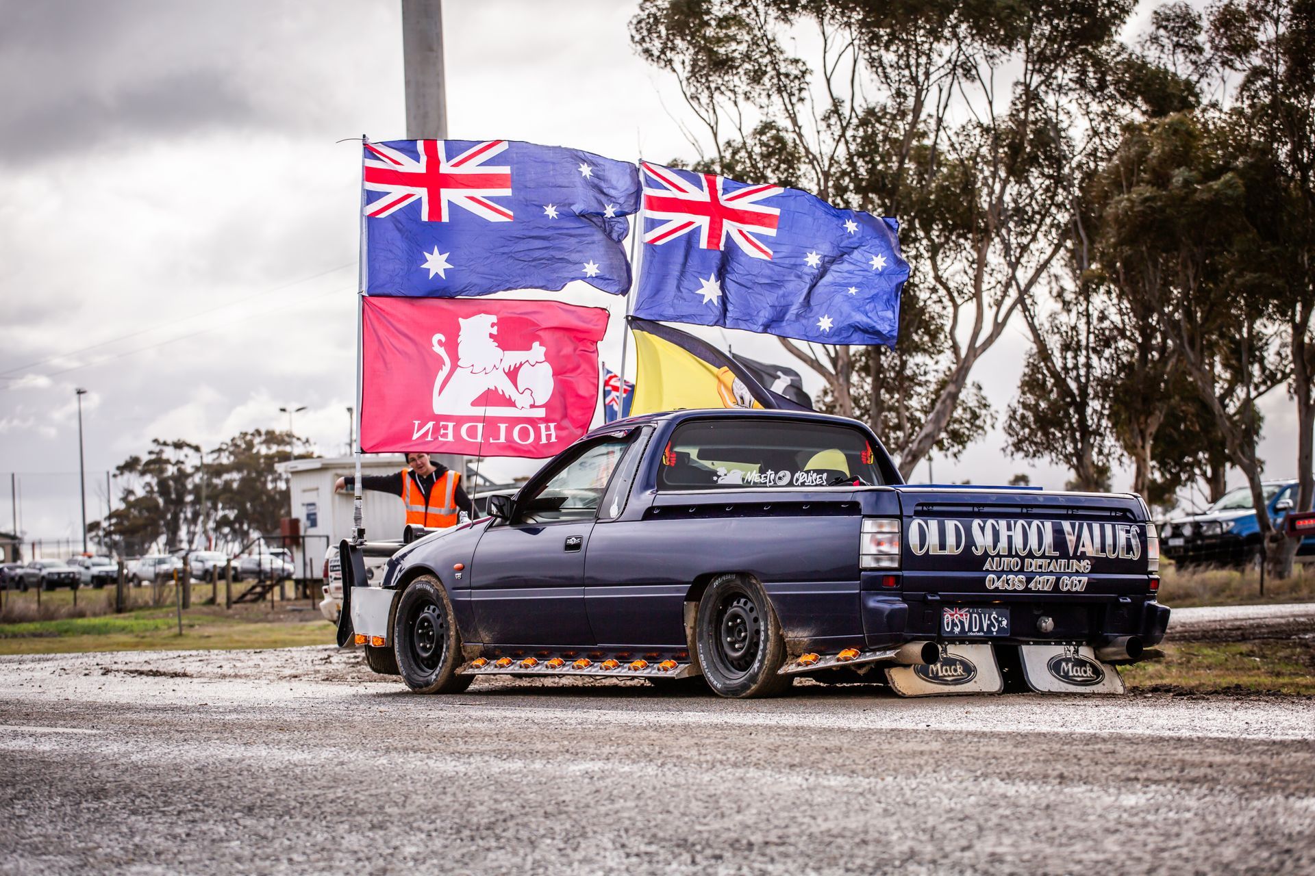 A truck is parked in front of a sign that says motor oil