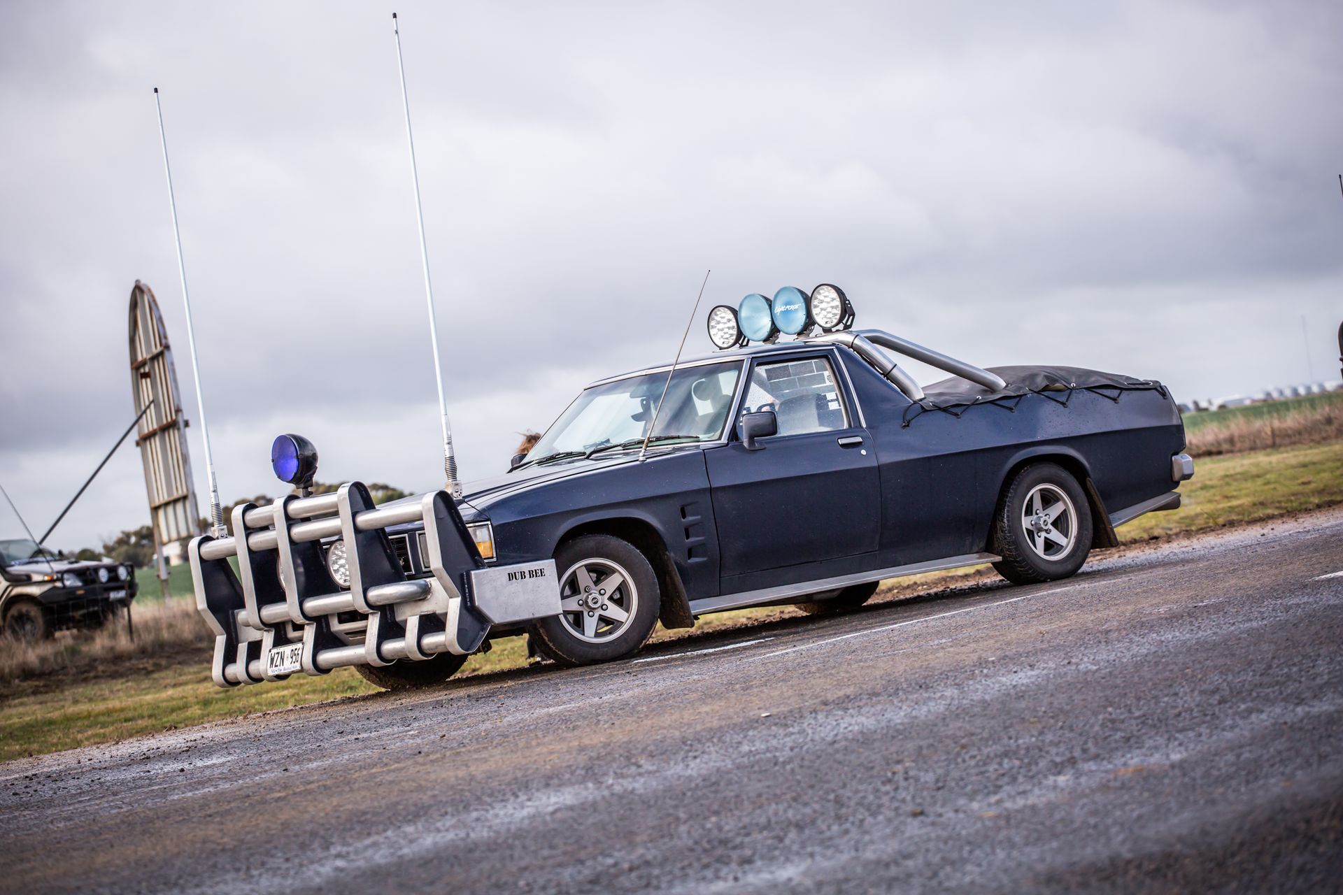 A black car is parked on the side of the road