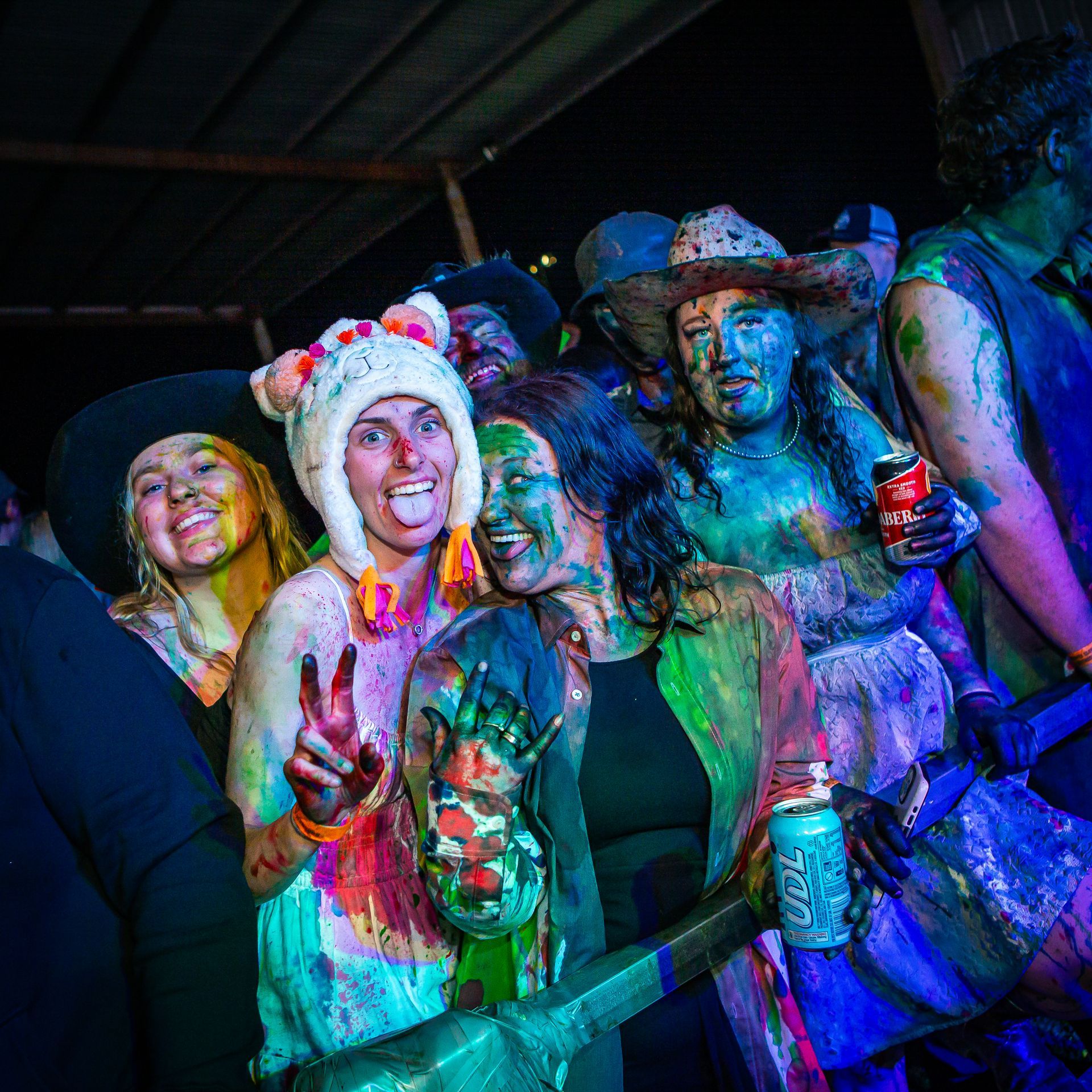 A group of people covered in paint are posing for a picture