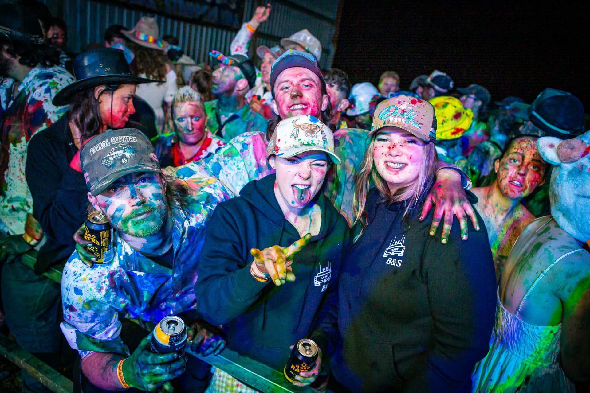 A group of people with their faces covered in paint are posing for a picture