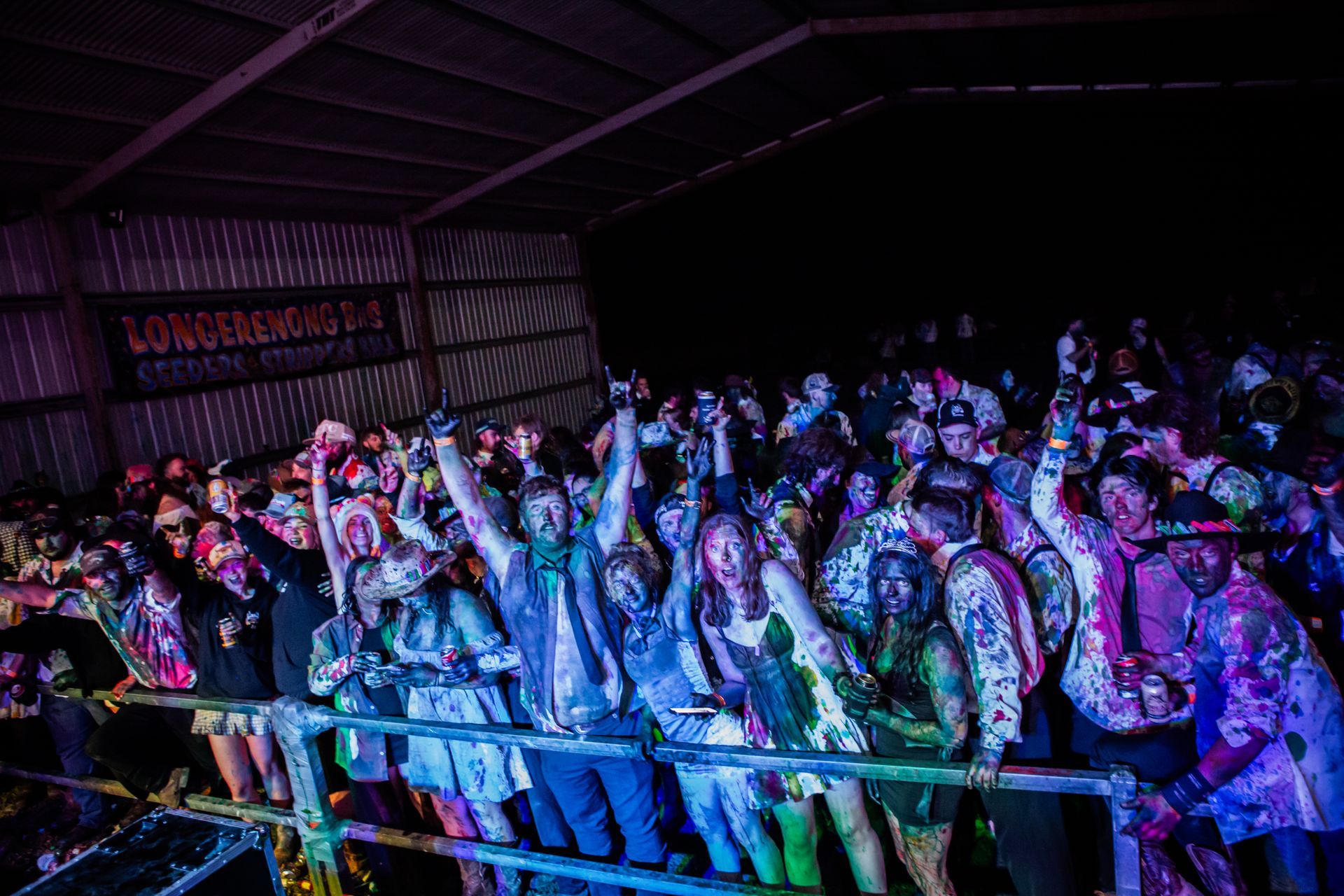 A crowd of people are standing in front of a sign that says loneliness