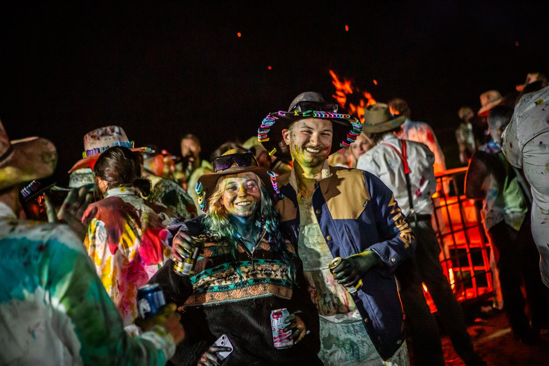 A man in a cowboy hat is surrounded by other people