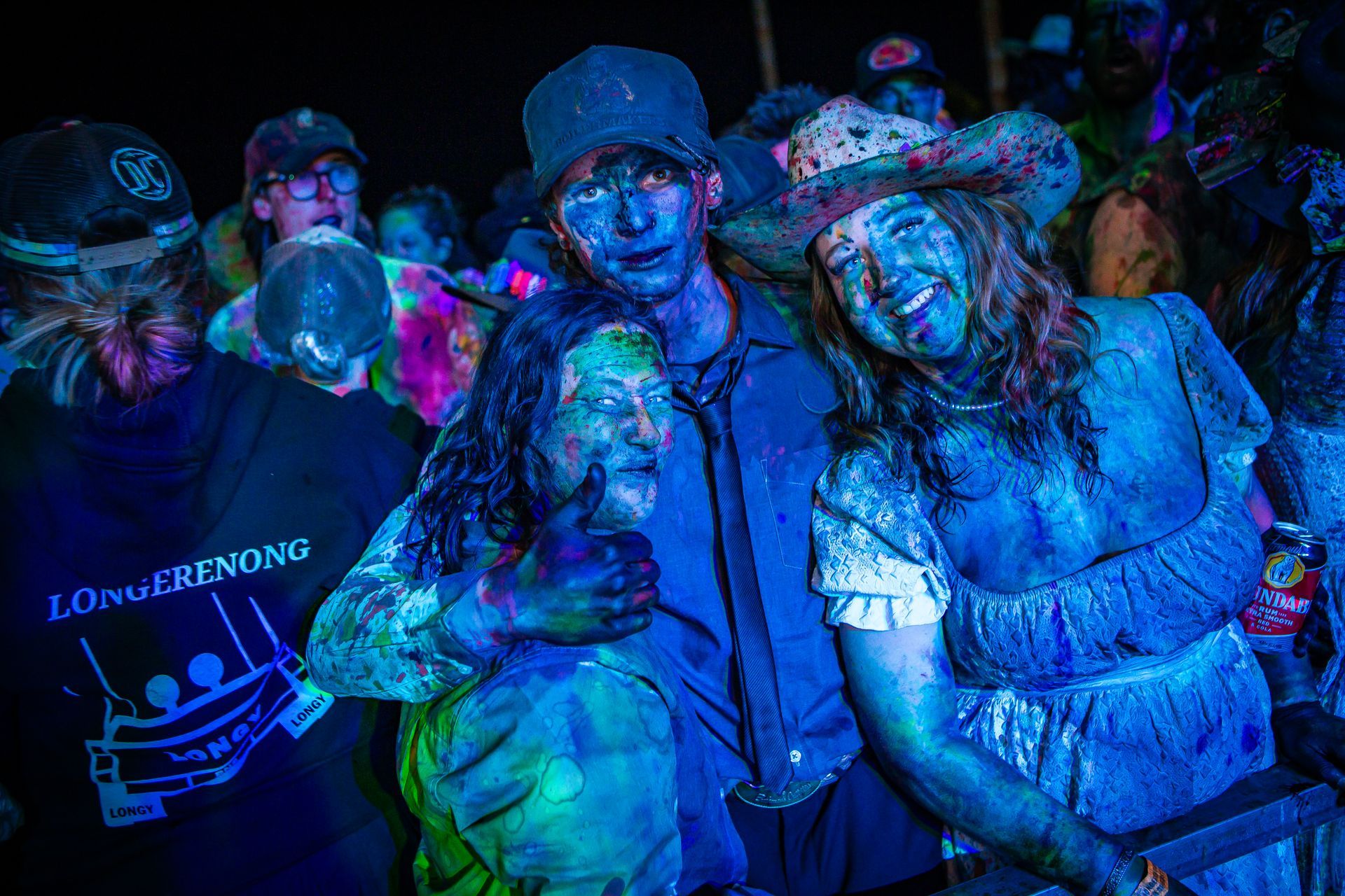 A group of people with blue paint on their faces including a man wearing a shirt that says 1 finger ending