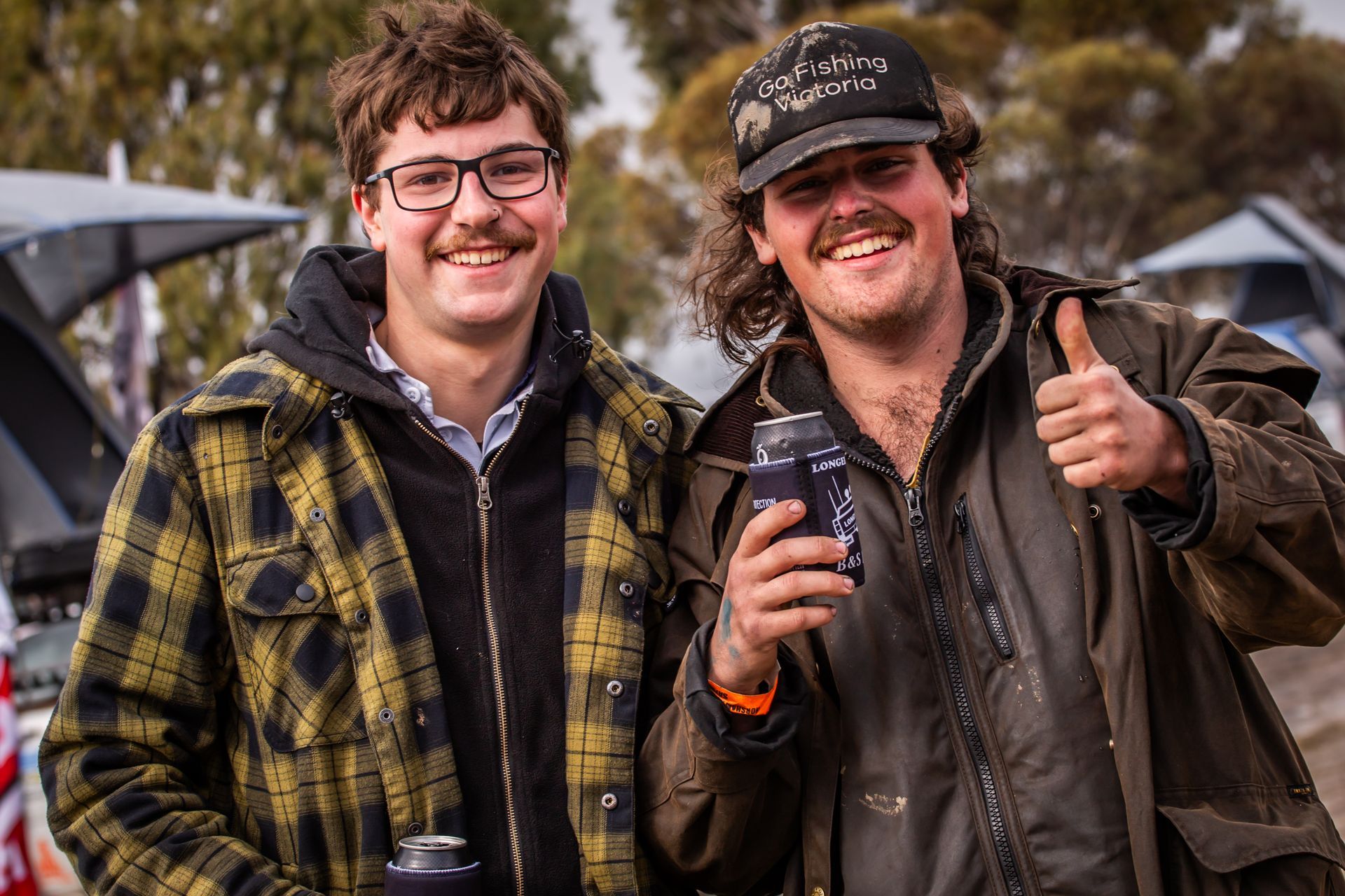 Two men standing next to each other with one wearing a hat that says ' i 'm a man ' on it