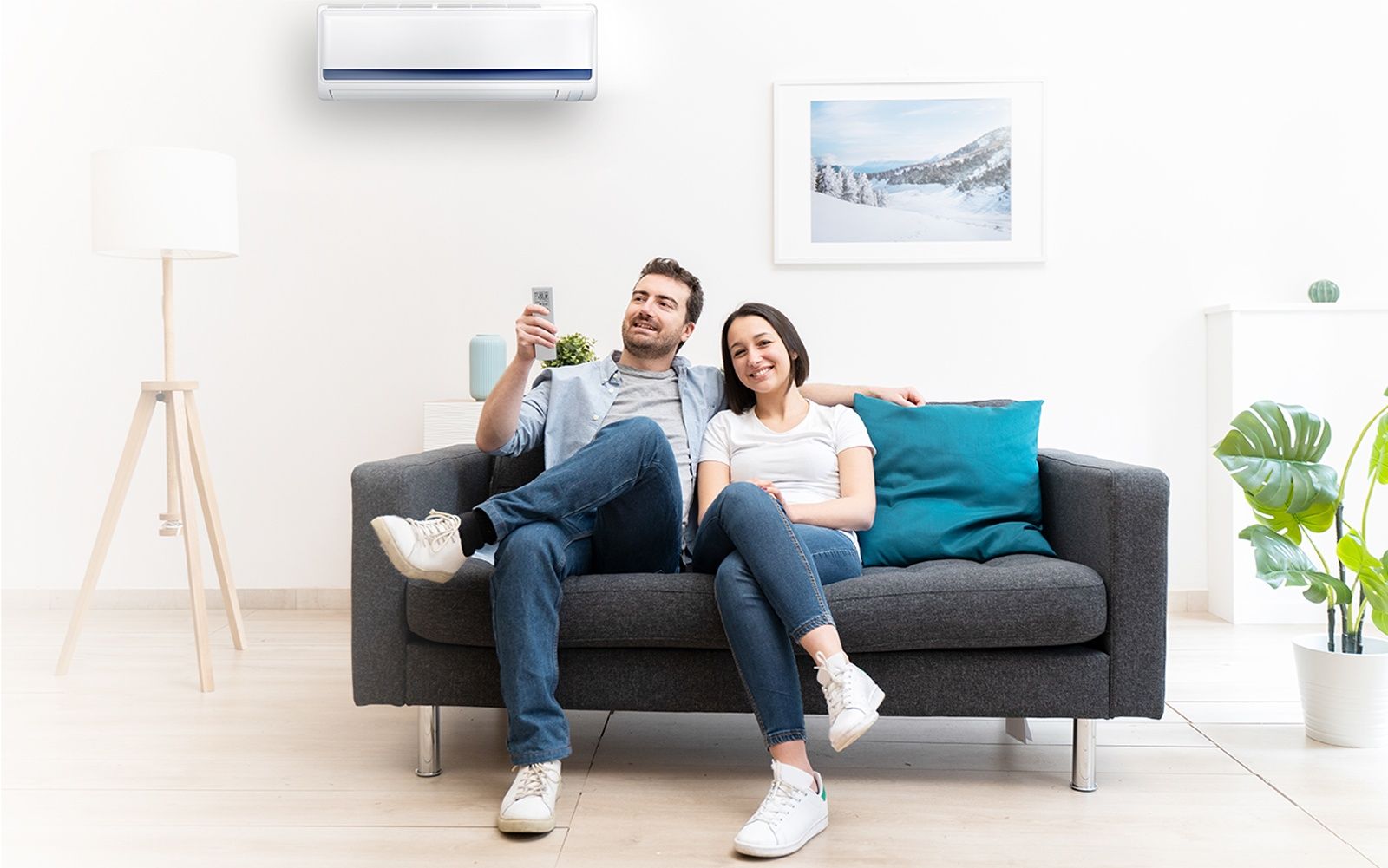 A man and a woman are sitting on a couch with a remote control.