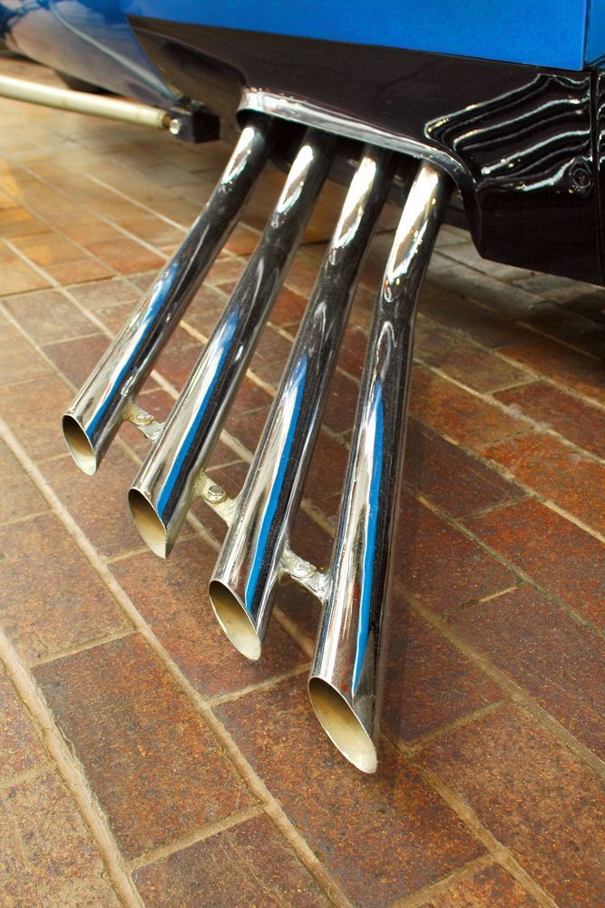 A Close Up Of A Car Exhaust Pipe On A Brick Floor — Tamworth Muffler Man In Tamworth, NSW