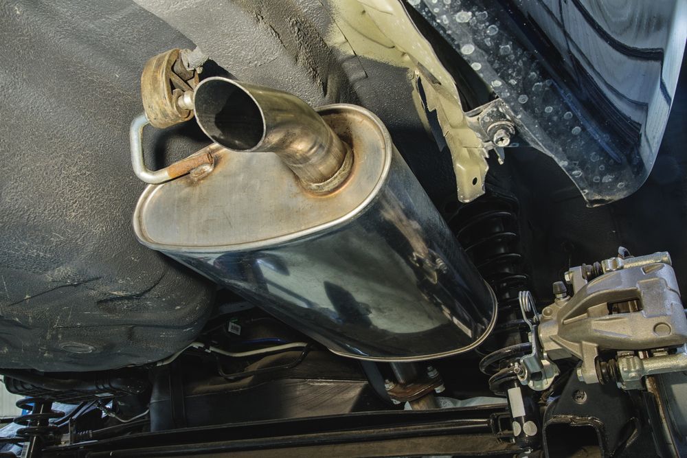 A Stainless Steel Exhaust Pipe Is Attached To The Underside Of A Car — Tamworth Muffler Man In Tamworth, NSW