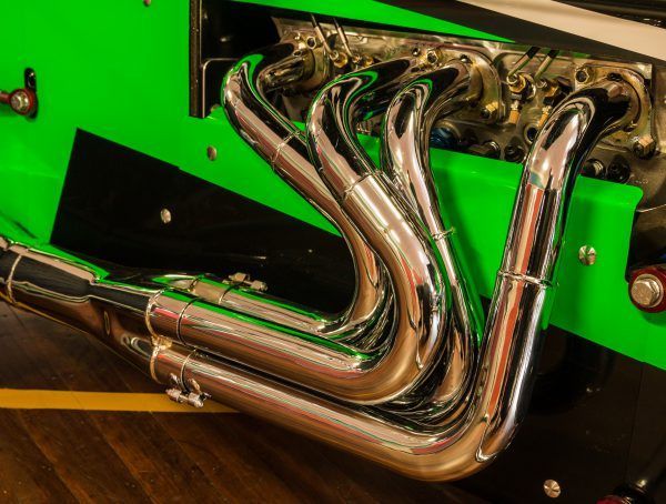 A Close Up Of The Exhaust Pipes Of A Green Car — Tamworth Muffler Man In Tamworth, NSW