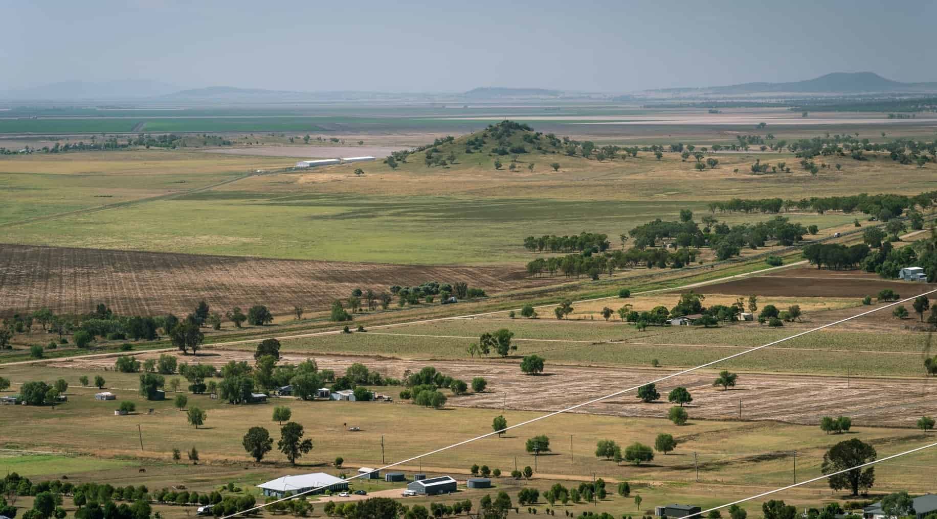 An Aerial View Of A Lush Green Field With Trees And A River In The Background — Tamworth Muffler Man In Gunnedah, NSW