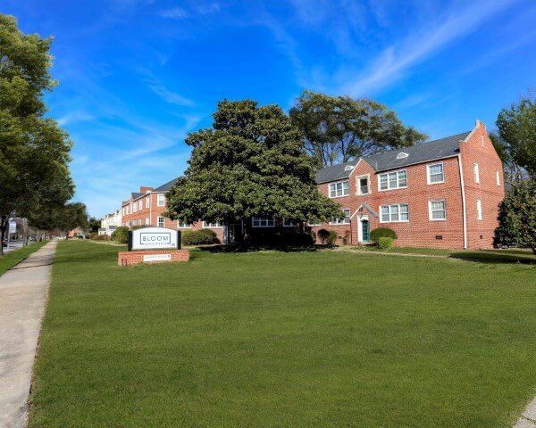 A brick building with a sign in front of it that says welcome
