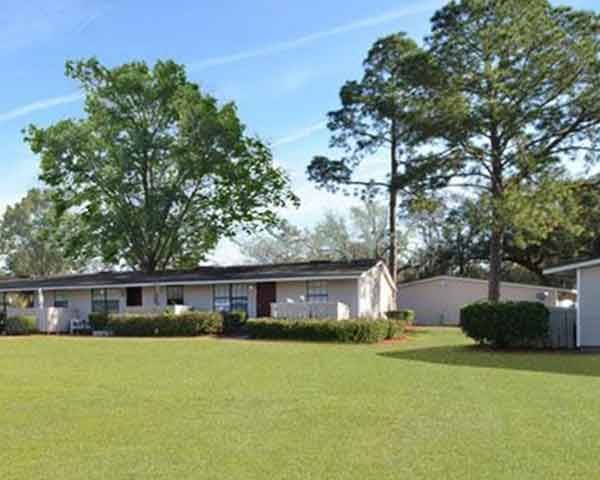 A house with a large lawn in front of it