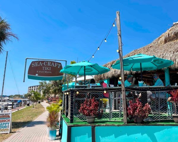 A restaurant with umbrellas and a sign that says sea craft tiki