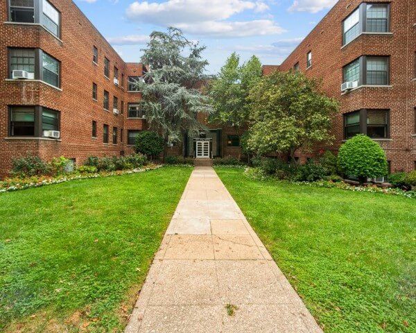A brick building with a walkway leading to it