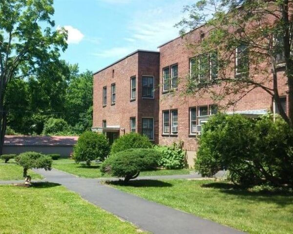A large brick building with trees in front of it