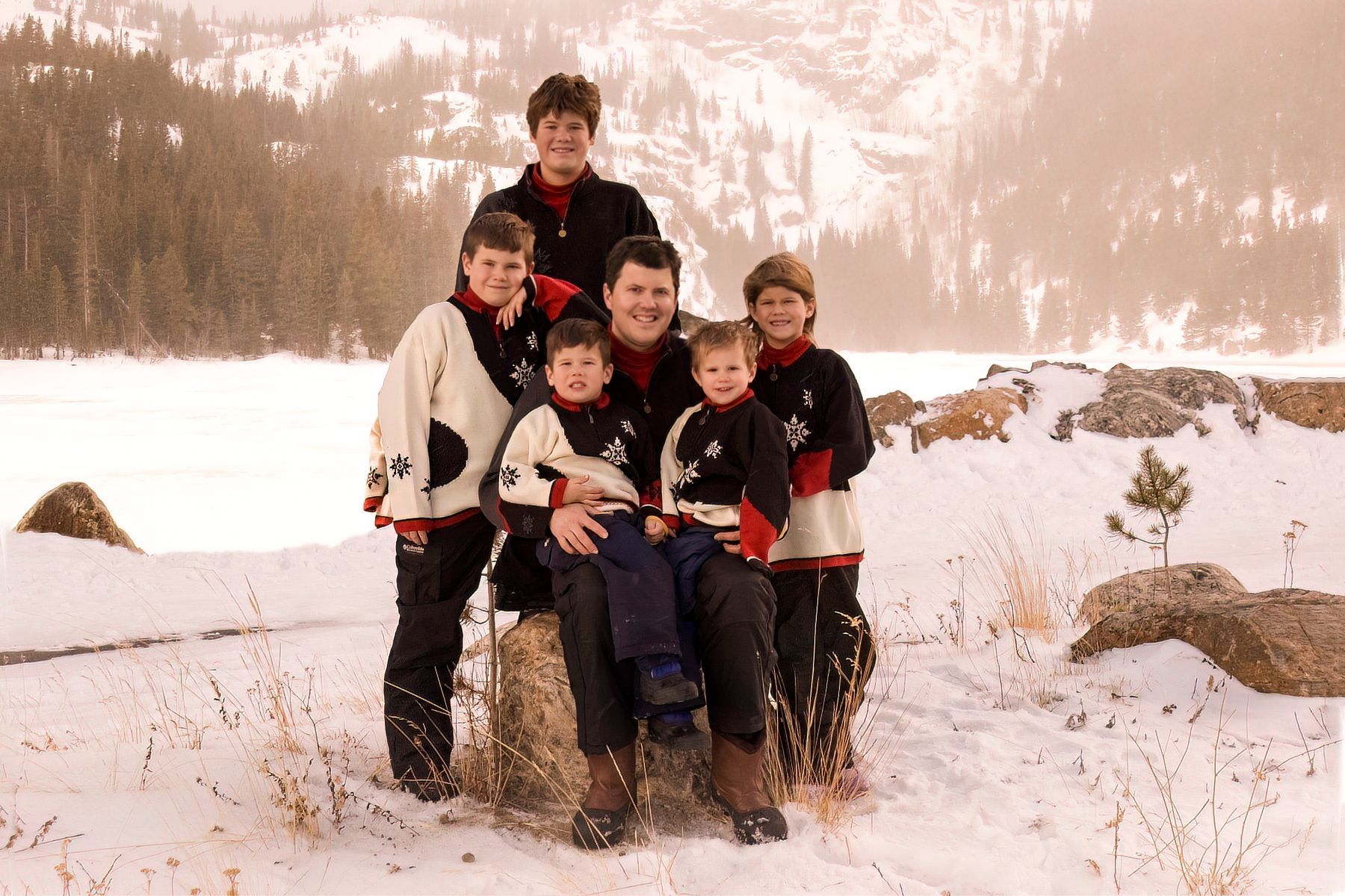 A group of people posing for a picture in the snow