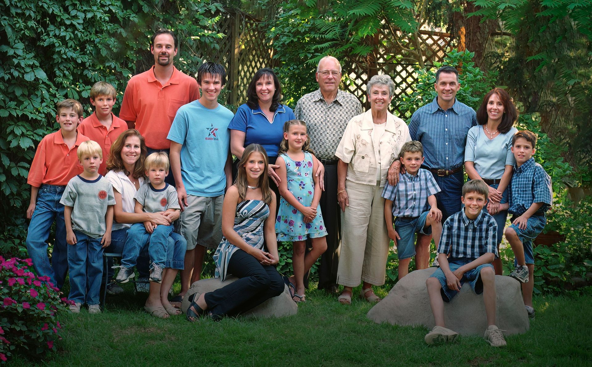 A large family posing for a picture in the grass