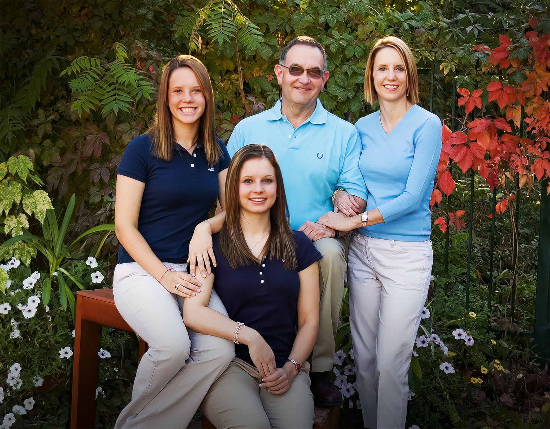 A group of people posing for a picture in a garden
