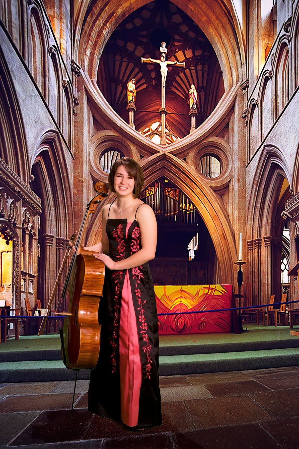 A woman in a red and black dress is holding a cello in a church.